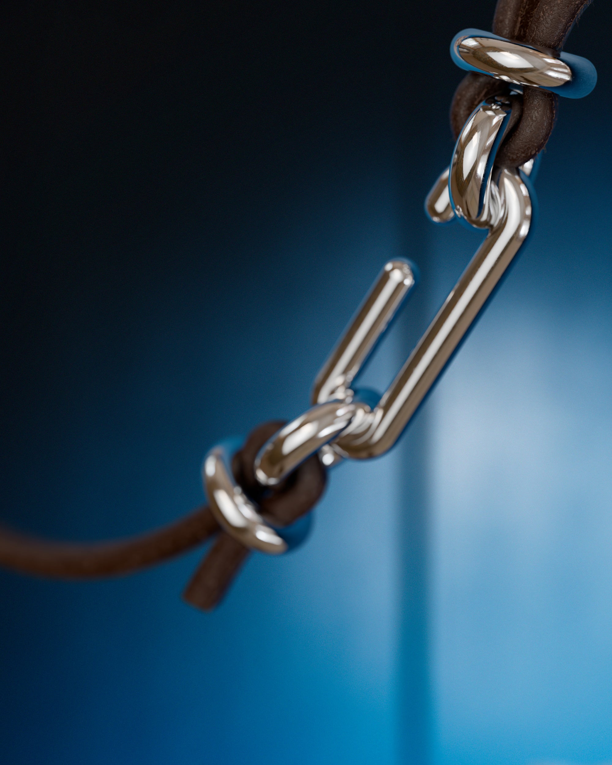 Detail of the handmade bracelet with leather dark band and silver clasp, from the BOND collection by OFFFHAND. Designed by Michael Rüscher.