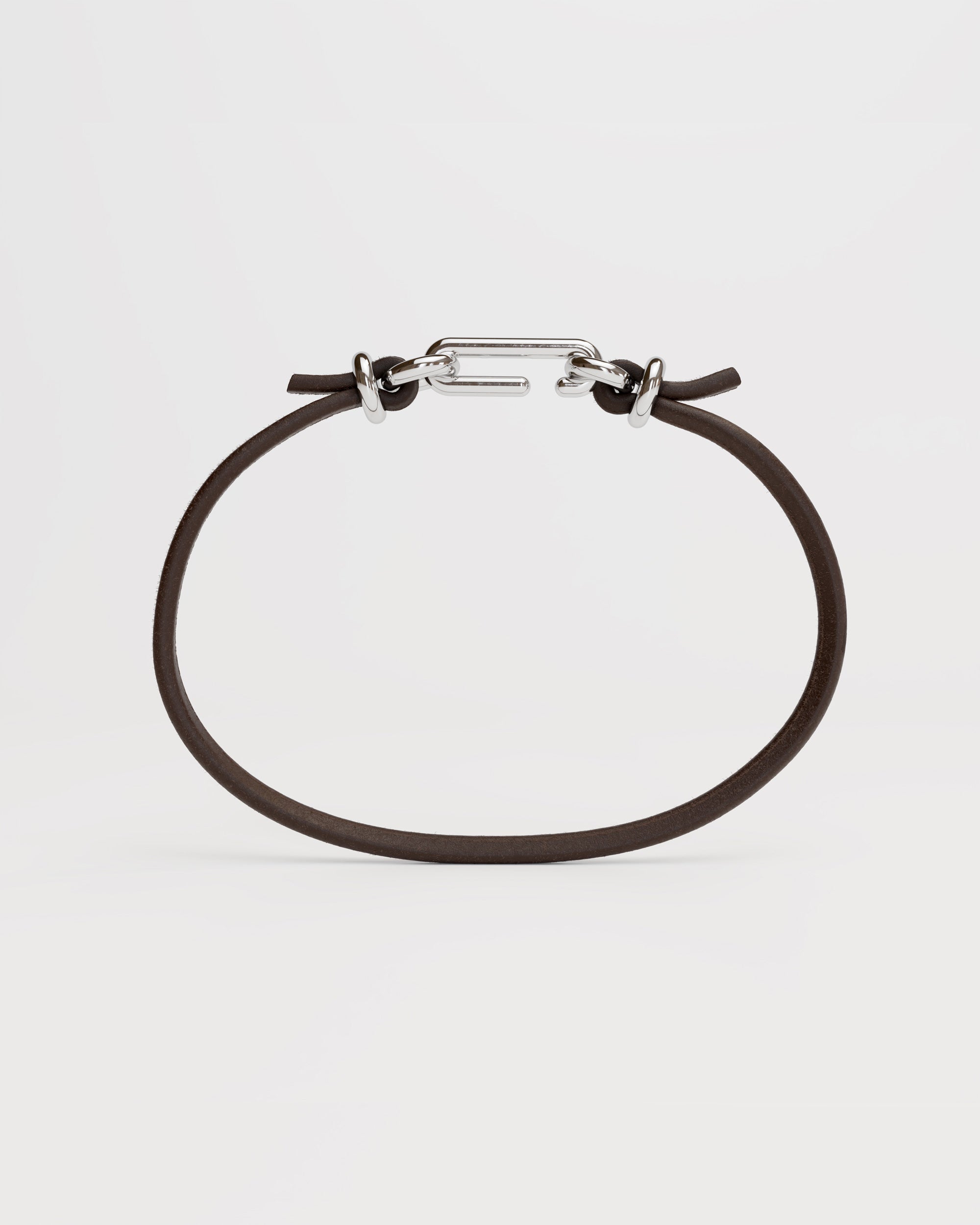 Packshot of the handmade bracelet with leather dark band and silver clasp, from the BOND collection by OFFFHAND. Designed by Michael Rüscher.