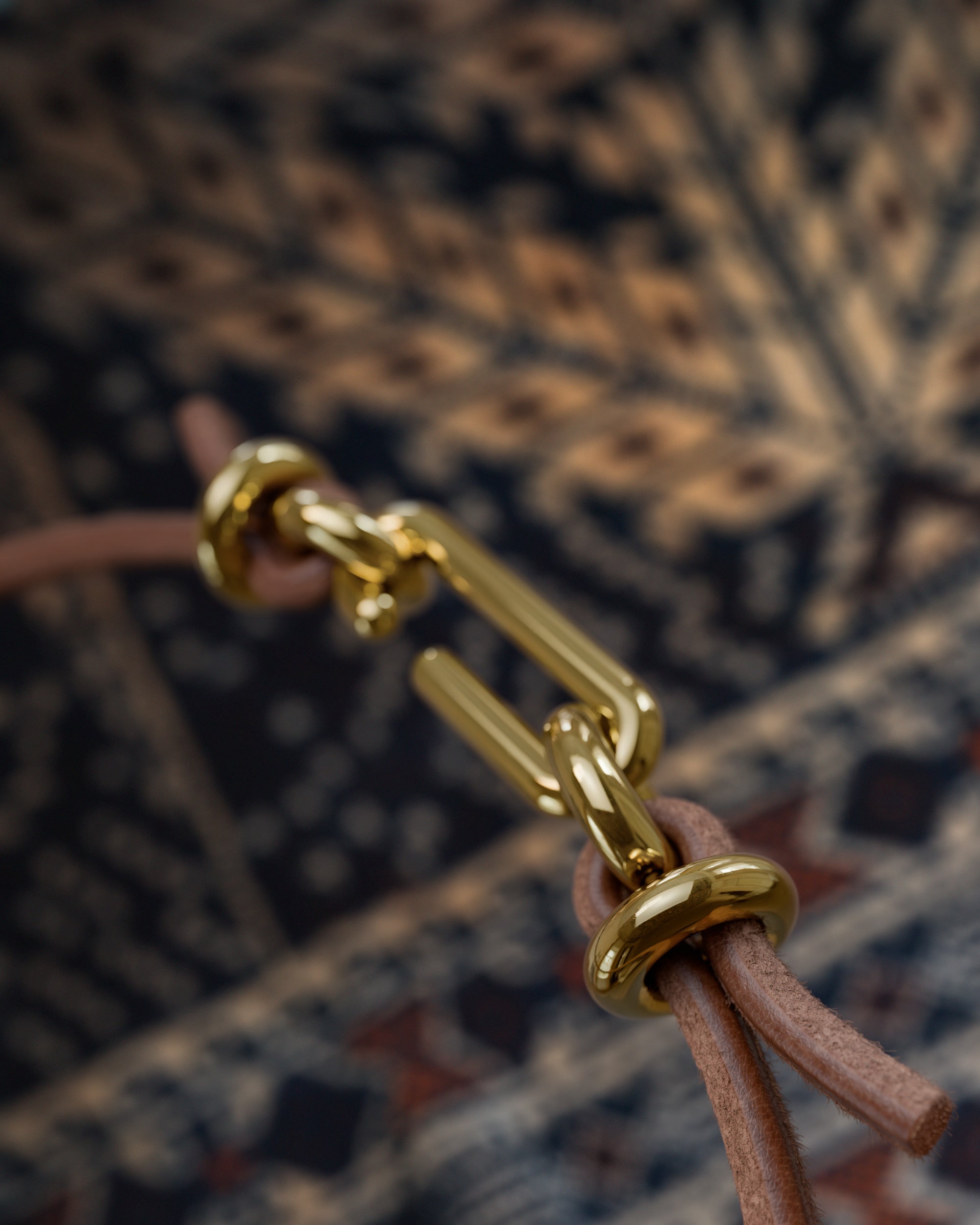 Detail of the handmade bracelet with leather light band and gold clasp, from the BOND collection by OFFFHAND. Designed by Michael Rüscher.