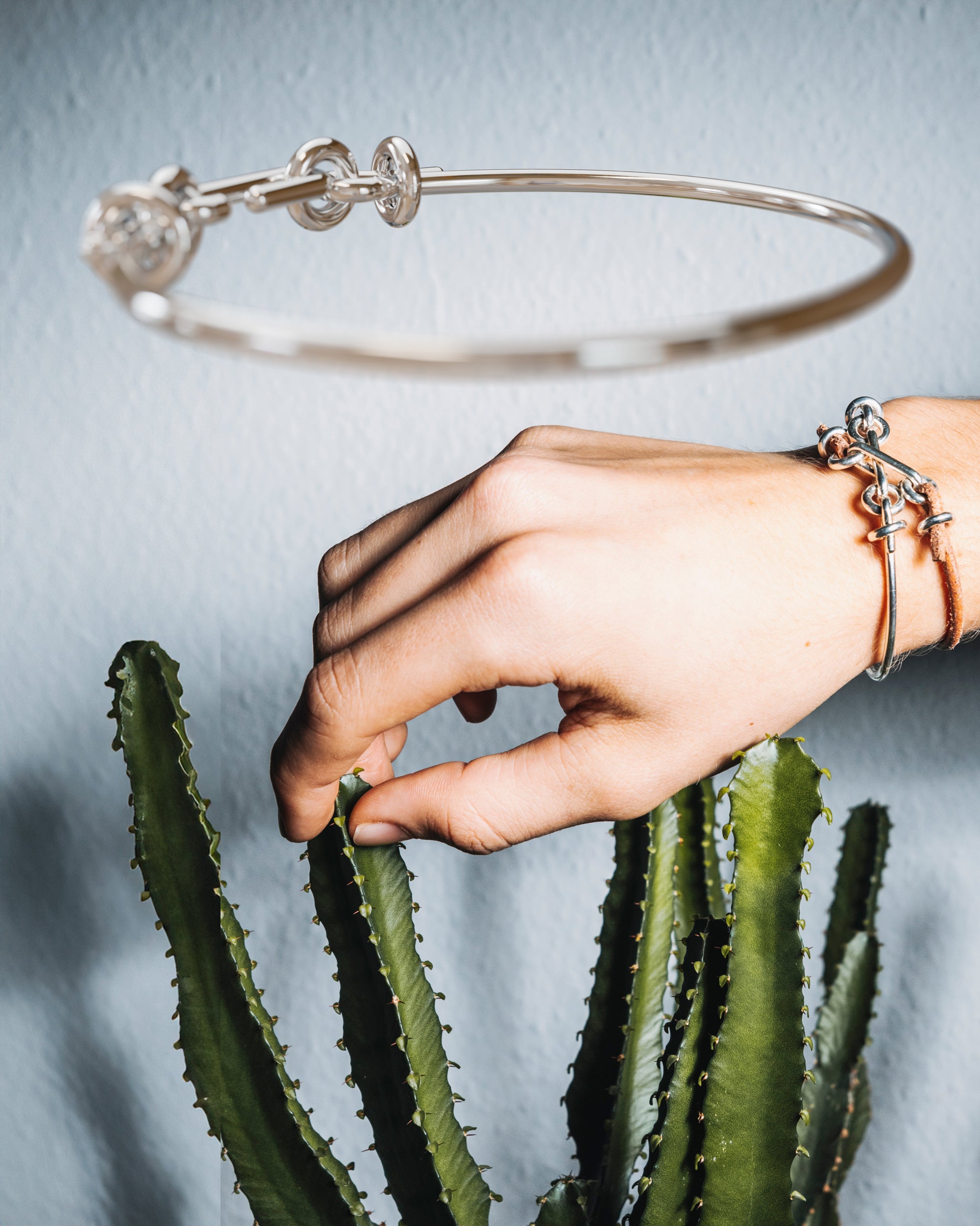 Collage of the handmade bracelet with silver band and silver clasp, from the BOND collection by OFFFHAND. Designed by Michael Rüscher.