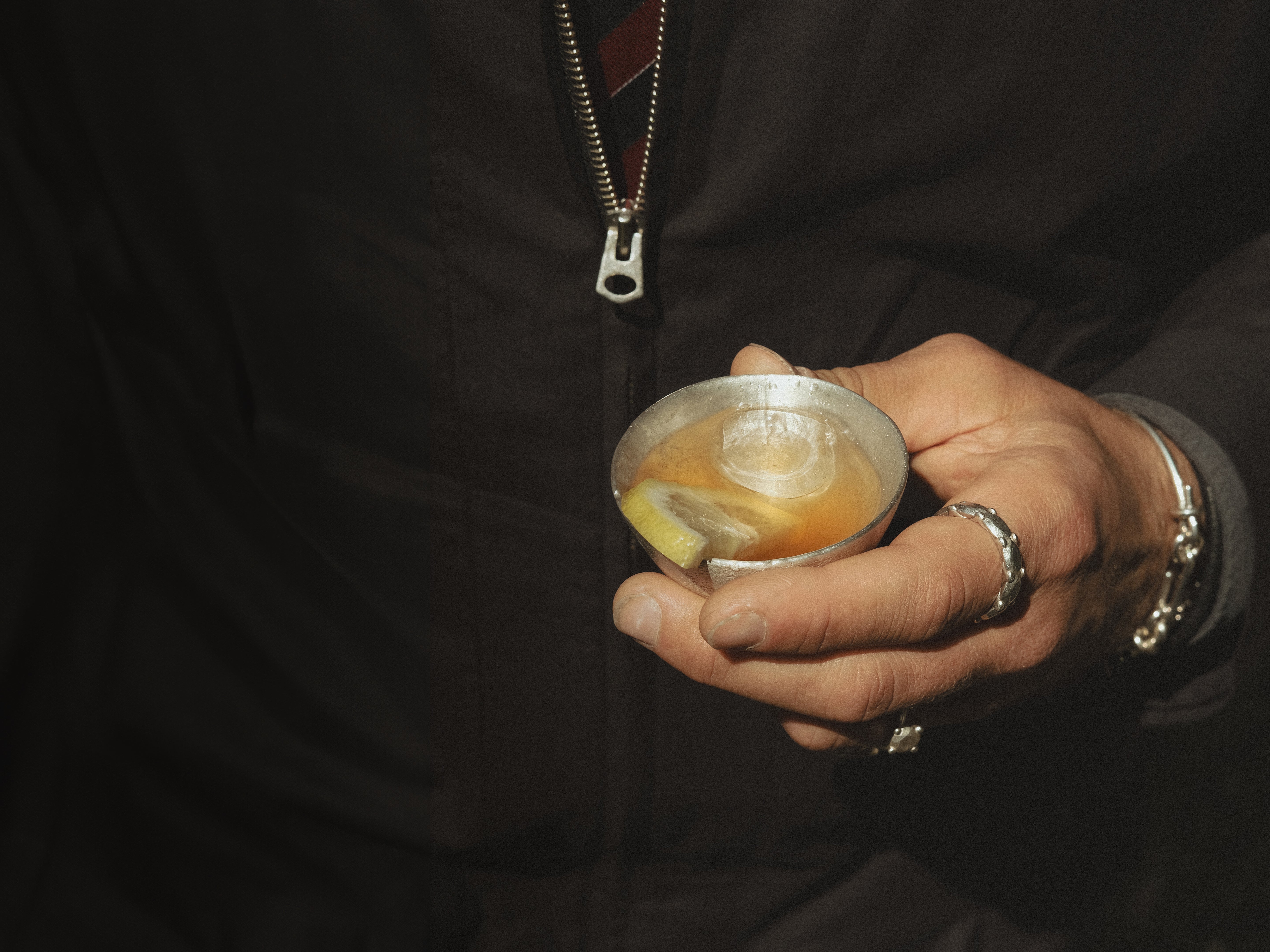 OFFFHAND founder Michael Rüscher holding the pure silver HOLD Cup with a small aperitivo inside.