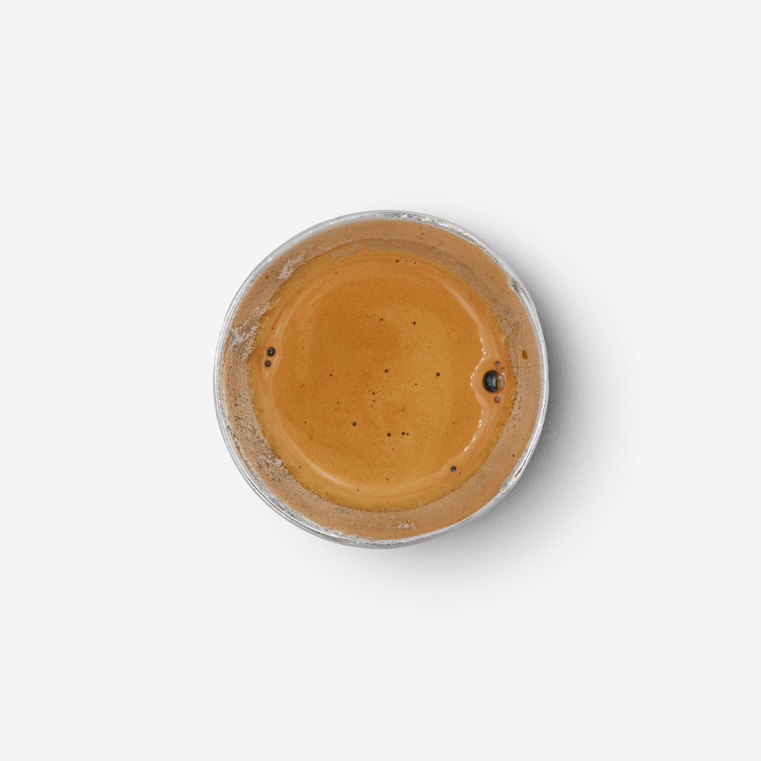 Top view of the OFFFHAND HOLD Cup made from pure silver and filled with coffee.