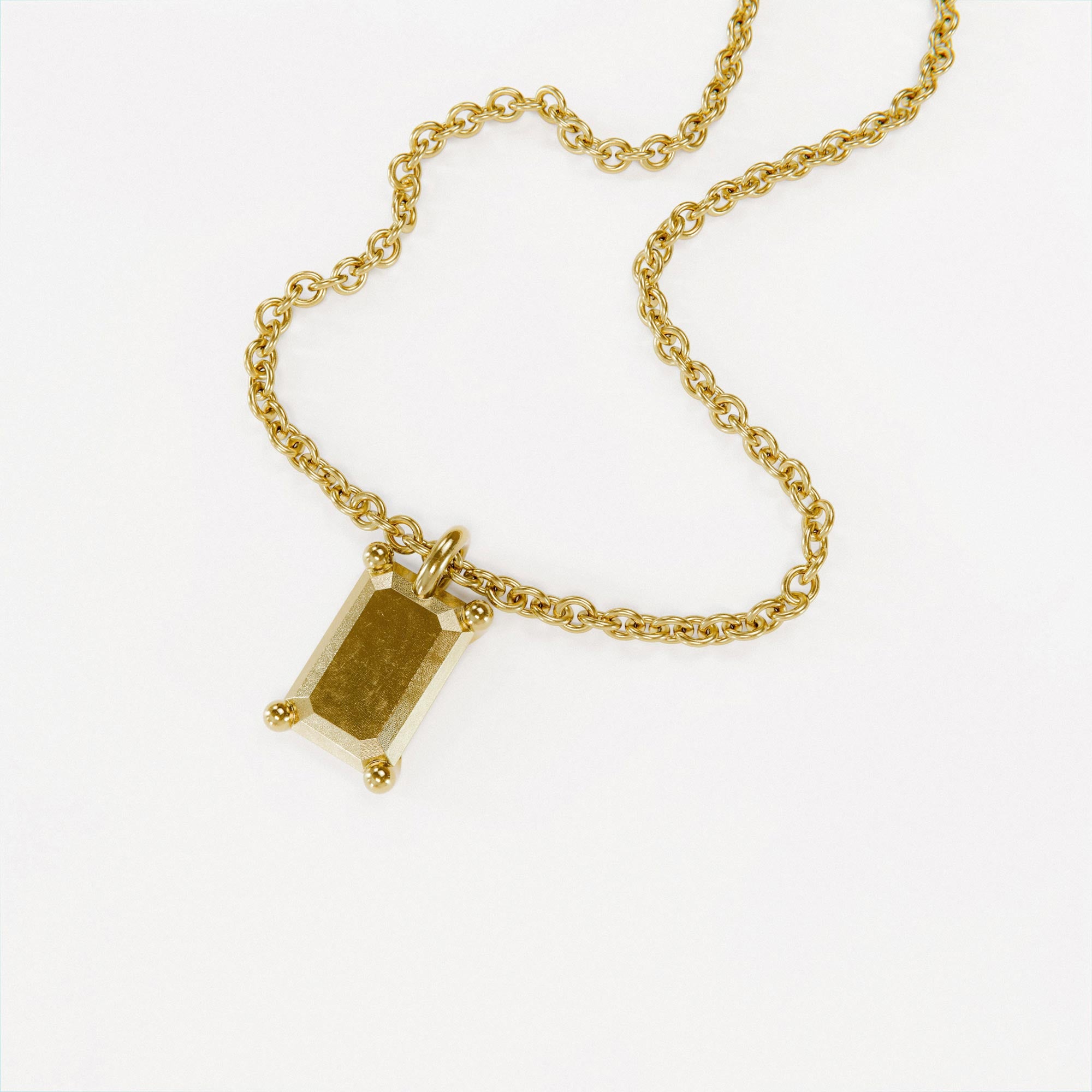 Handmade small gold emerald charm from the LOST collection by OFFFHAND. Designed by Michael Rüscher.
