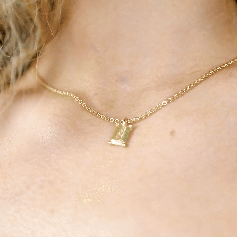 Handmade small gold emerald charm from the LOST collection by OFFFHAND. Designed by Michael Rüscher.