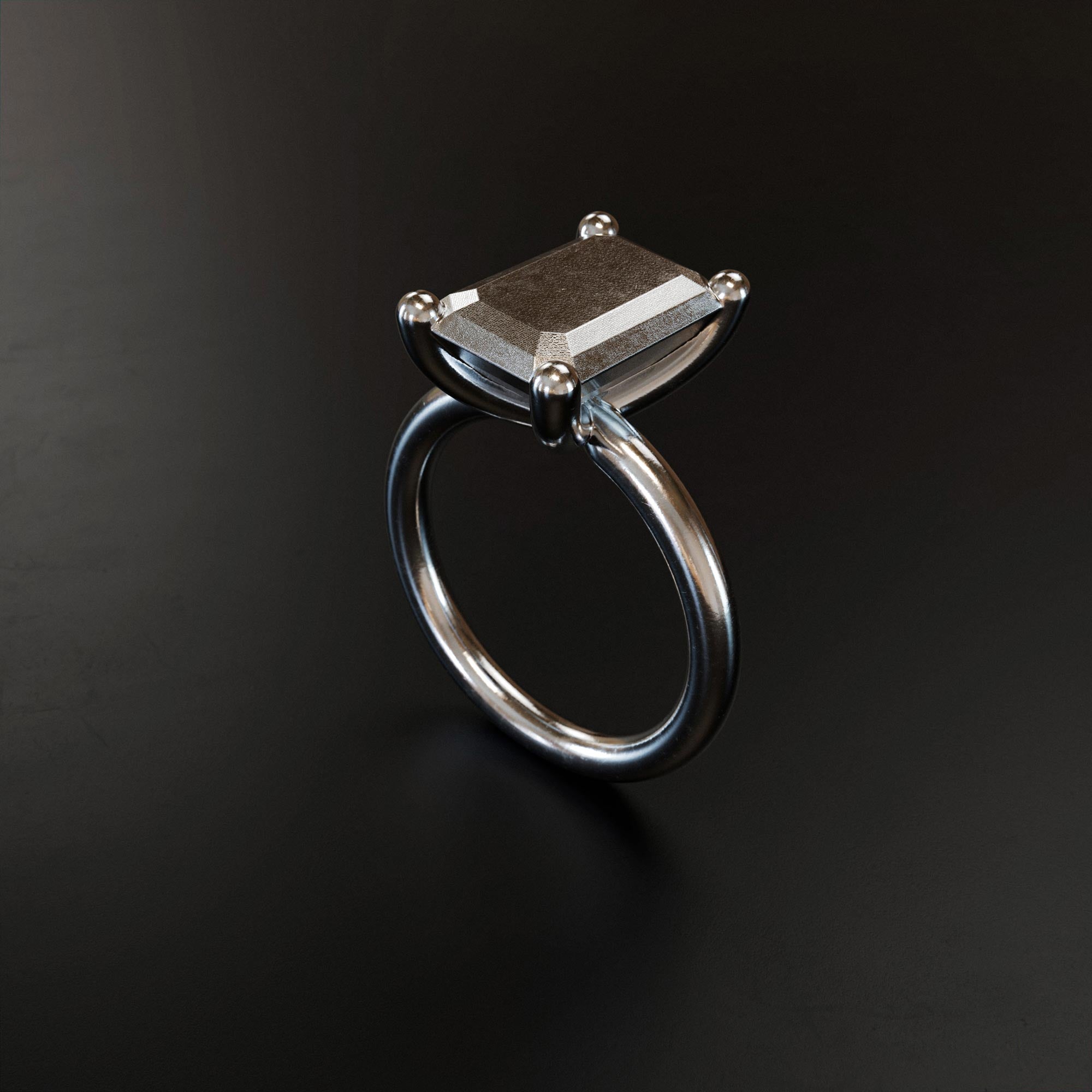 Handmade small platinum emerald ring from the LOST collection by OFFFHAND. Designed by Michael Rüscher.