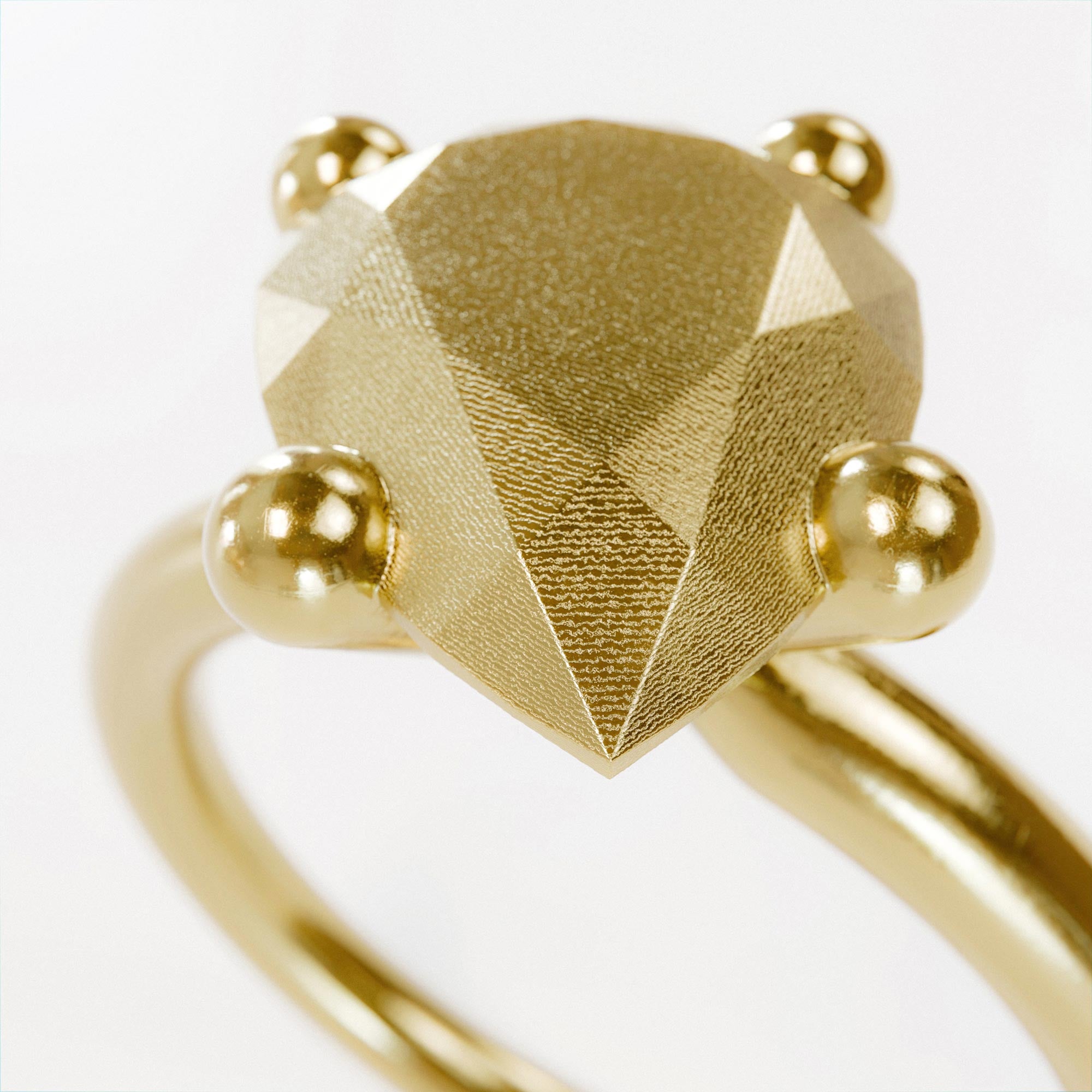 Detail view of the handmade small gold pear ring from the LOST collection by OFFFHAND. Designed by Michael Rüscher.