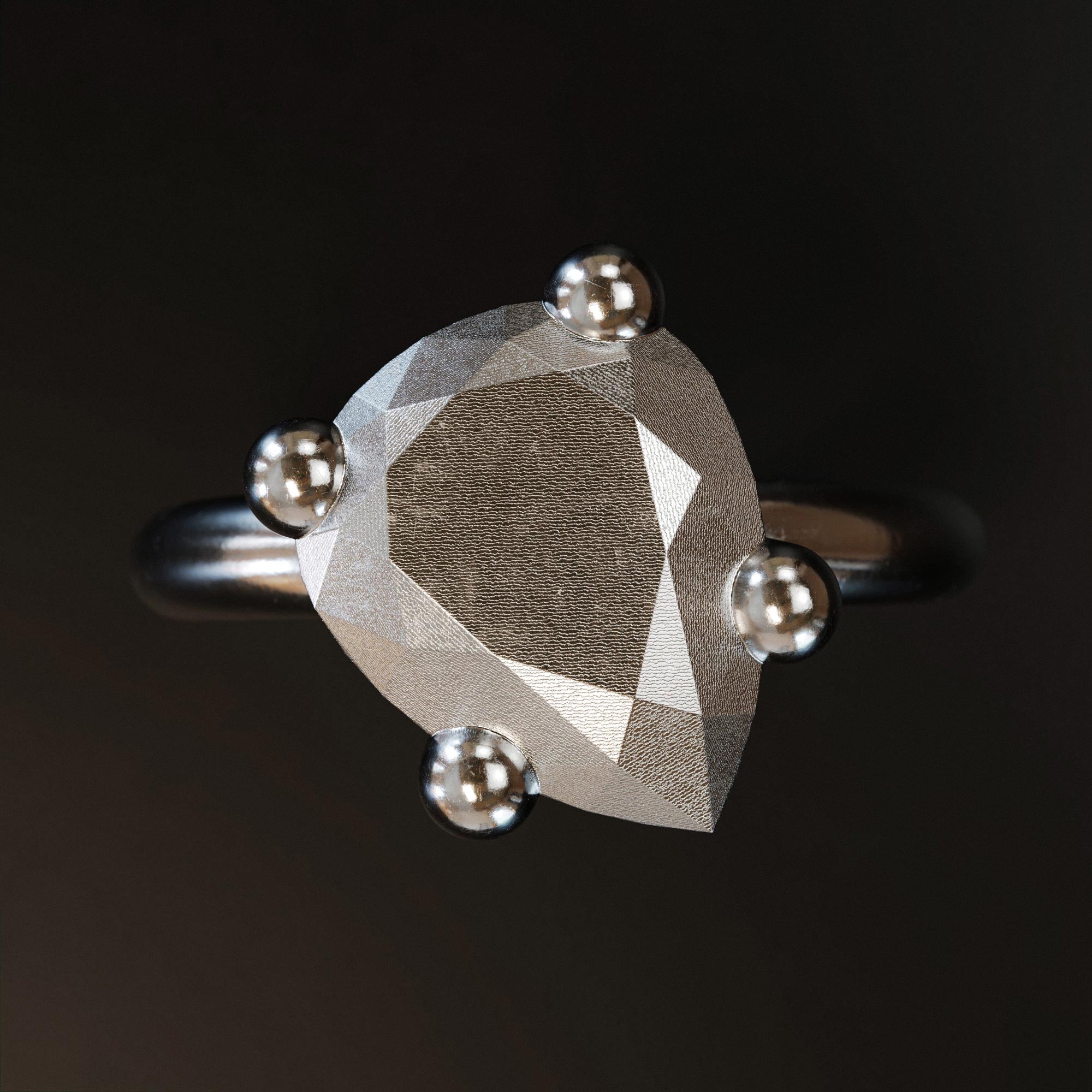 Detail view of the handmade small platinum pear ring from the LOST collection by OFFFHAND. Designed by Michael Rüscher.