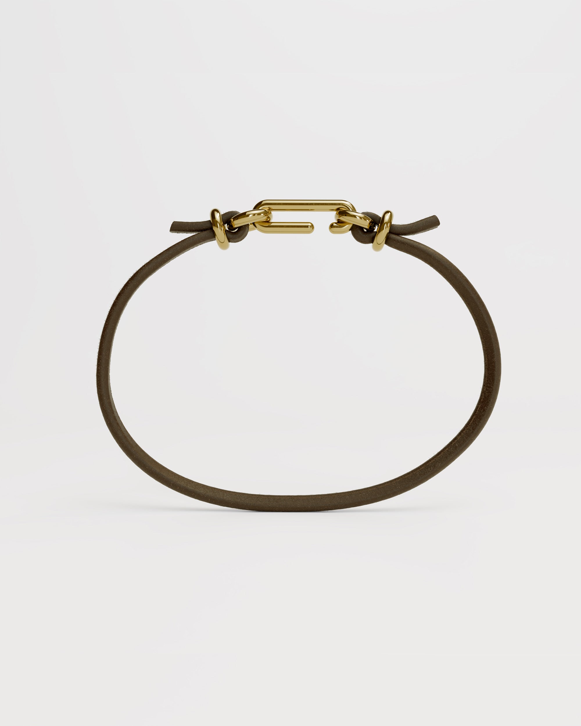Packshot of the handmade bracelet with leather dark band and gold clasp, from the BOND collection by OFFFHAND. Designed by Michael Rüscher.