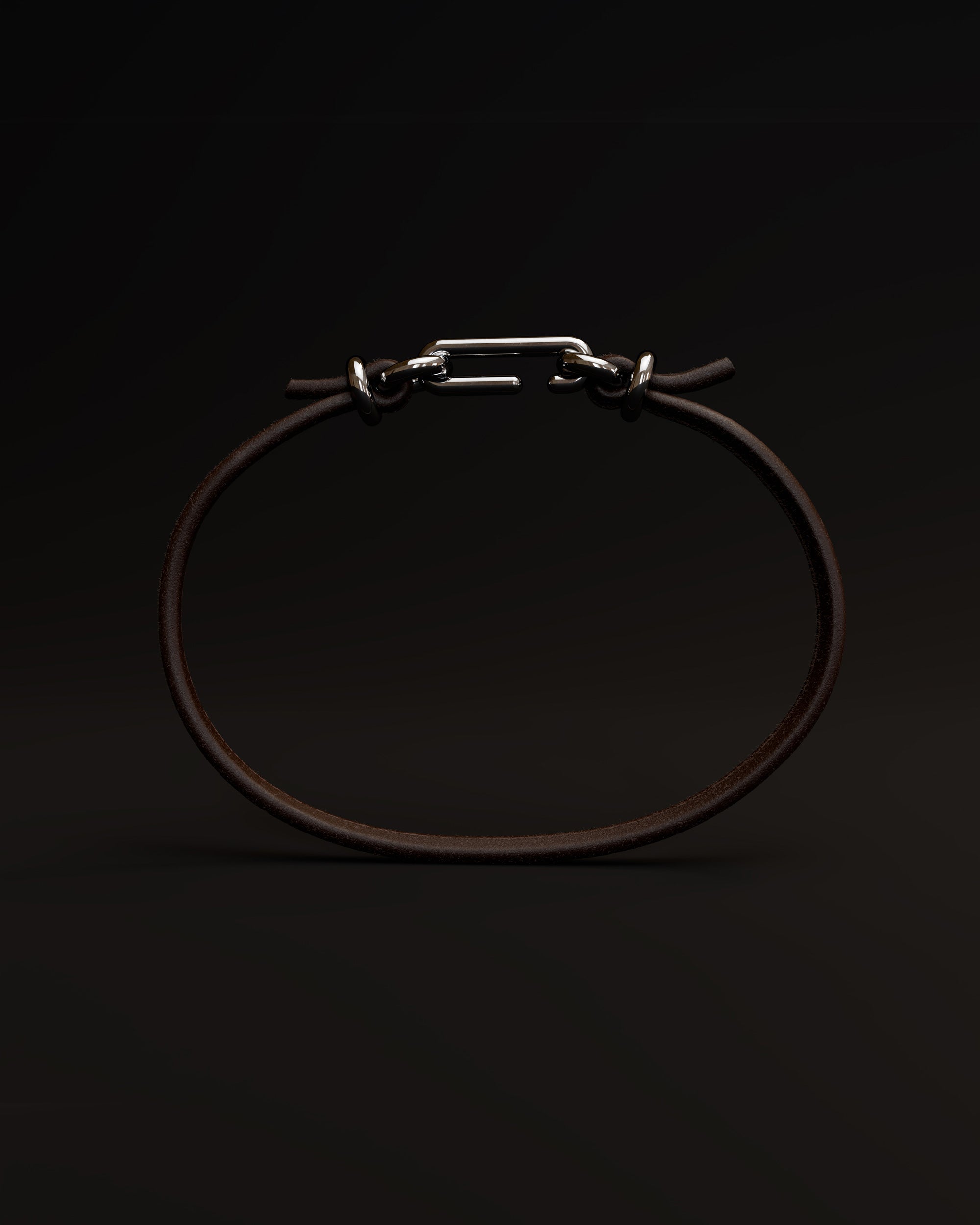 Packshot of the handmade bracelet with leather dark band and platinum clasp, from the BOND collection by OFFFHAND. Designed by Michael Rüscher.
