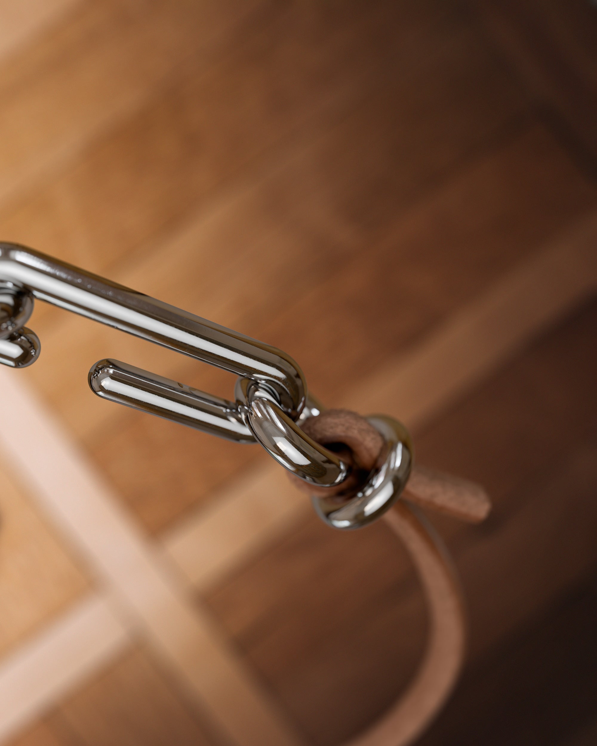 Detail of the handmade bracelet with leather light band and platinum clasp, from the BOND collection by OFFFHAND. Designed by Michael Rüscher.